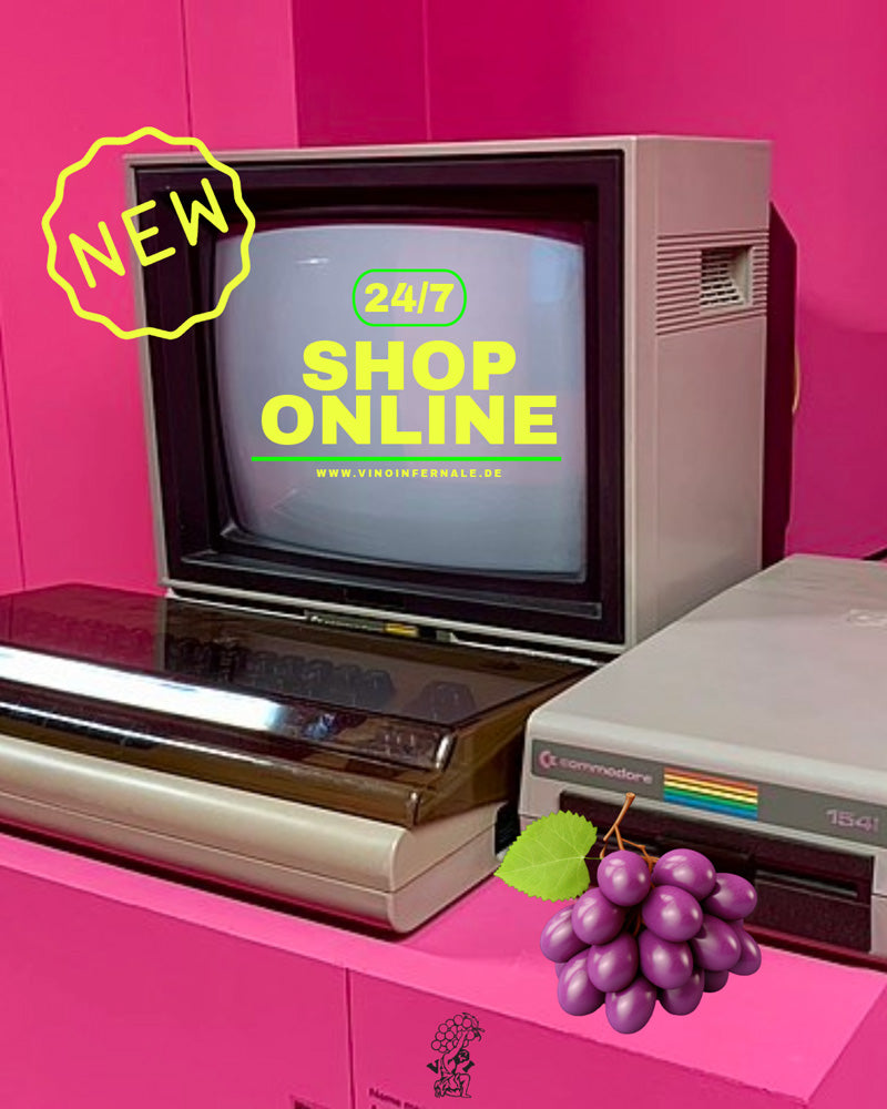 Retro-Computer-Setup vor pinkem Hintergrund mit Text 'Shop Online' und einer Weintraube.